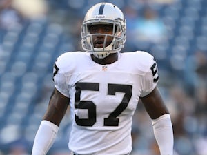 Linebacker Kaelin Burnett of the Oakland Raiders warms up prior to the game against the Seattle Seahawks at CenturyLink Field on August 30, 2012 
