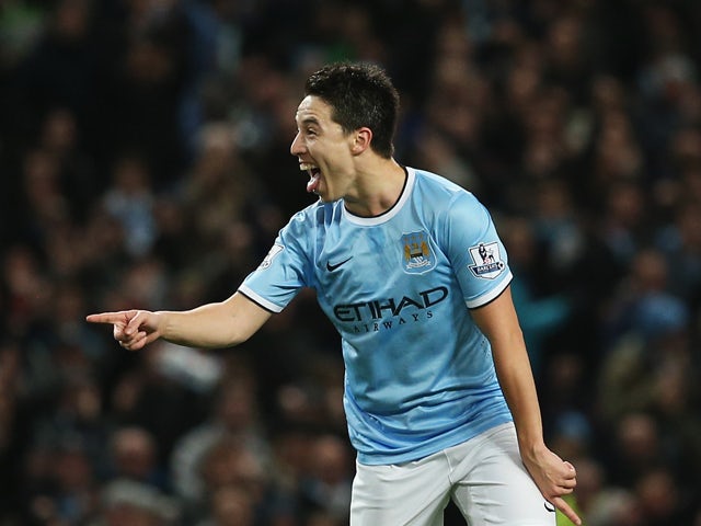 Samir Nasri of Manchester City celebrates his team's second goal during the Barclays Premier League match between Manchester City and Swansea City at Etihad Stadium on December 1, 2013