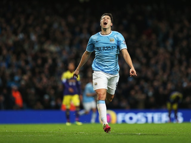 Samir Nasri of Manchester City celebrates his team's third goal during the Barclays Premier League match between Manchester City and Swansea City at Etihad Stadium on December 1, 2013
