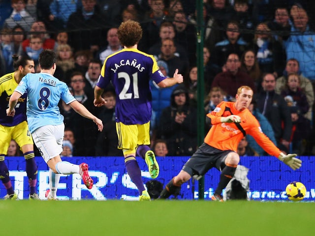 Samir Nasri of Manchester City scores his team's third goal during the Barclays Premier League match between Manchester City and Swansea City at Etihad Stadium on December 1, 2013