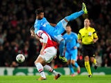 Mario Lemina of Marseille climbs on Olivier Giroud of Arsenal during the UEFA Champions League Group F match between Arsenal and Olympique de Marseille at Emirates Stadium on November 26, 2013