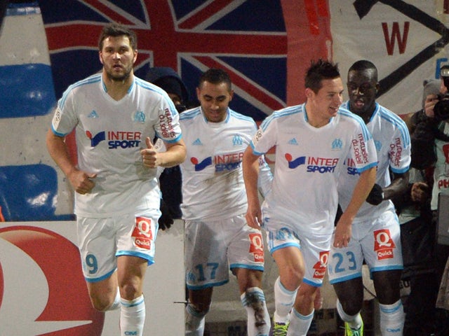 Marseille's French midfielder Florian Thauvin celebrates with teammates after scoring on November 29, 2013