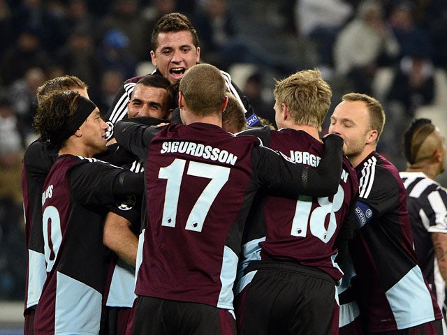 Copenhagen's Olof Mellberg is congratulated by teammates after scoring his team's opening goal against Juventus during their Champions League group match on November 27, 2013
