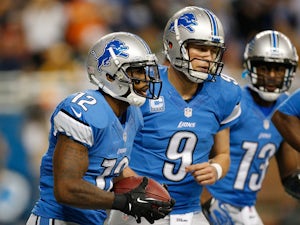 Jeremy Ross #12 of the Detroit Lions celebrates a second quarter touchdown with Matthew Stafford #9 and Nate Burleson #13 while playing the Green Bay Packers at Ford Field on November 28, 2013