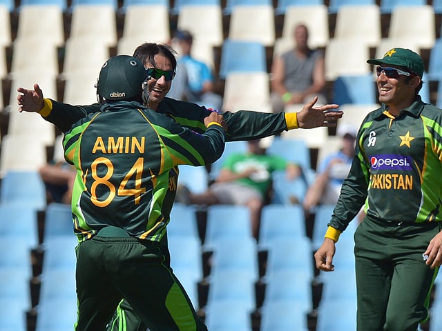 Pakistan's cricketer Saeed Ajma celebrates with team-mates after taking the wicket of South Africa's batsman Henry Davids, during the final One-Day Internationals match between South Africa and Pakistan at SuperSport in Centurion on November 30, 2013