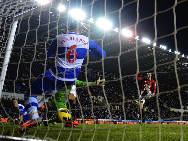 Robin van Persie of Manchester United sees his shot cross the line despite being cleared by Adrian Mariappa of Reading during the Barclays Premier League match on December 1, 2012