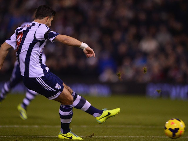 Shane Long of West Bromwich Albion scores their first goal during the Barclays Premier League match between West Bromwich Albion and Aston Villa at The Hawthorns on November 25, 2013