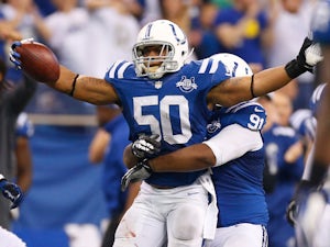 Jerrell Freeman #50 of the Indianapolis Colts celebrates a fourth quarter interception with Ricardo Mathews #91 while playing the Tennessee Titans at Lucas Oil Stadium on December 1, 2013