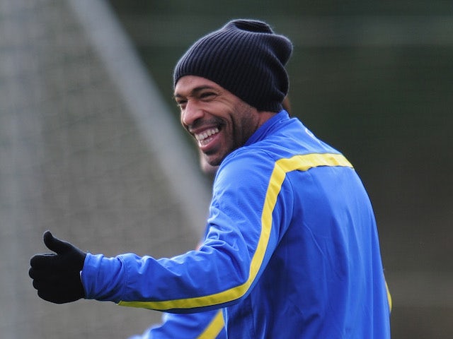 Former Arsenal player Thierry Henry warms up during a training session at London Colney on November 25, 2013