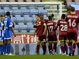 Zulte Waregem's Thorgan Hazard is congratulated by teammates after scoring his team's opening goal against Wigan during their Europa League group match on November 28, 2013