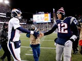 Quarterbacks Peyton Manning and Tom Brady shake hands after the New England Patriots defeated the Denver Broncos on November 24, 2013