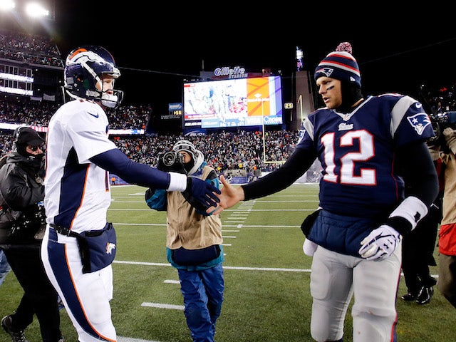 Quarterbacks Peyton Manning and Tom Brady shake hands after the New England Patriots defeated the Denver Broncos on November 24, 2013
