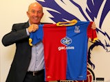 Tony Pulis poses with a team shirt after being unveiled as the new Crystal Palace Manager on November 25, 2013