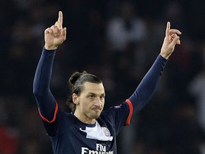 Paris Saint-Germain's Zlatan Ibrahimovic celebrates after scoring the opening goal against Olympiakos during their Champions League group match on November 27, 2013