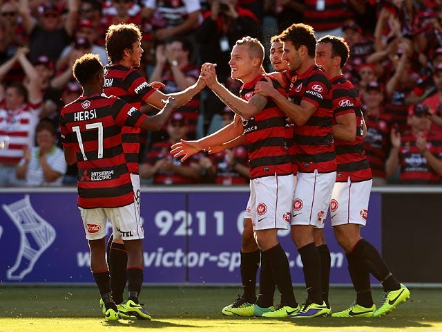 Western Sydney's Aaron Mooy celebrates with teammates after scoring the equaliser against Melbourne Heart during their A-League match on December 7, 2013