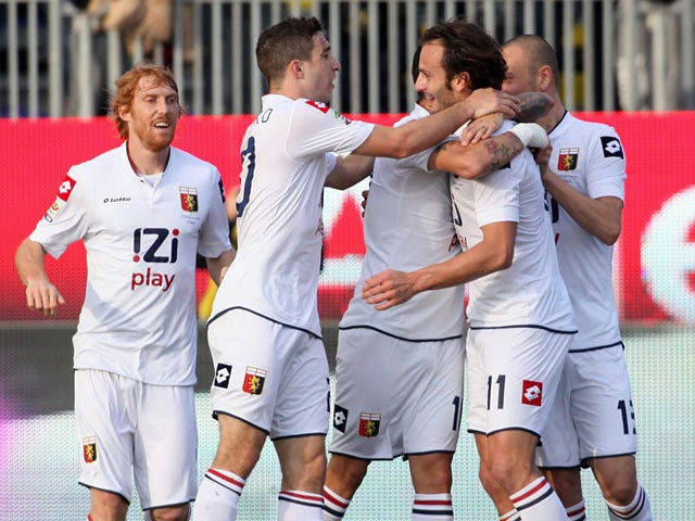 Genoa's Alberto Gilardino celebrates with teammates after scoring the opening goal against Cagliari Calcip on December 8, 2013