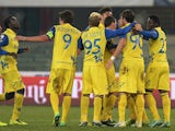 Chievo Verona's Alberto Paloschi is congratulated by teammates after scoring his team's second goal against Reggina during their Coppa Italia match on December 2, 2013