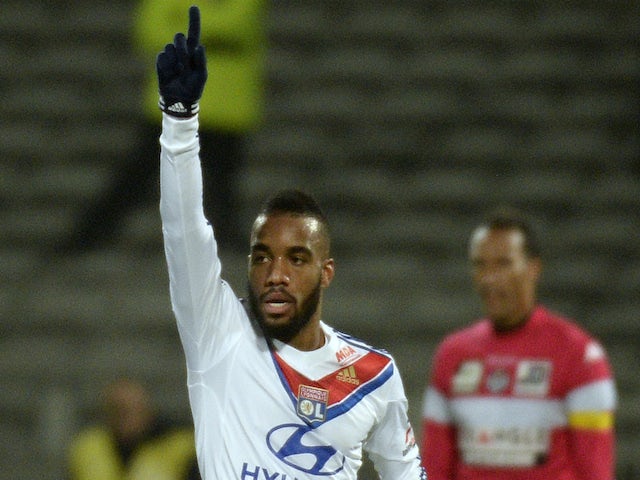 Lyon's French forward Alexandre Lacazette reacts after scoring during the French Ligue 1 football match against Toulouse FC on December 5, 2013