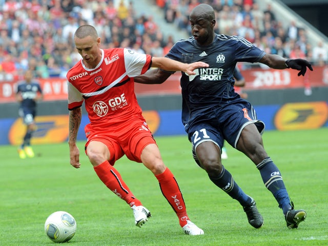 Valenciennes' French forward Anthony Le Tallec vies with Marseille's Senegalese defender Souleymane Diawara during a French L1 football match between Valenciennes and Marseille on August 24, 2013