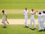Stuart Broad of England is congratulated by team mates after taking the wicket of David Warner of Australia during day one of the Second Ashes Test Match between Australia and England at Adelaide Oval on December 5, 2013