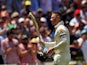 Australian captain Michael Clarke receives a standing ovation as he leaves the field following his dismissal for his 148 run innings against England during day two of the second Ashes Test cricket match in Adelaide on December 6, 2013