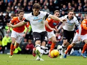 Derby's Chris Martin scores his team's opening goal via the penalty spot against Blackpool during their Championship match on December 7, 2013