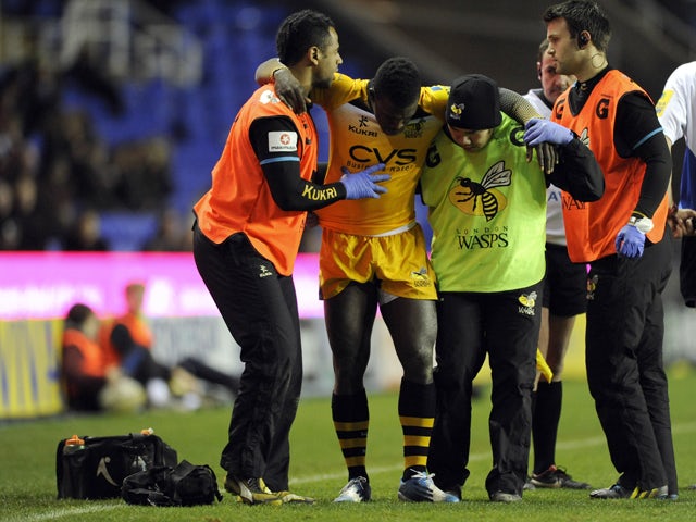 Christian Wade of London Wasps leaves the pitch after a suspected injury to his ankle during the Aviva Premiership Rugby match between London Irish and London Wasps at the Madejski Stadium on November 30, 2013