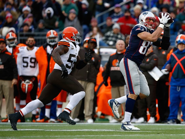 Rob Gronkowski #87 of the New England Patriots catches a pass before being hit by T.J. Ward #43 and D'Qwell Jackson #52 of the Cleveland Browns in the third quarter during the game at Gillette Stadium on December 8, 2013