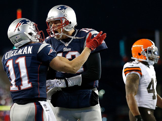 Tom Brady #12 of the New England Patriots celebrates the game-winning touchdown with Julian Edelman #11 in the 4th quarter at Gillette Stadium on December 8, 2013