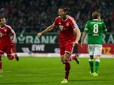 Bayern Munich's Daniel van Buyten celebrates after scoring his team's second goal against Werder Bremen during their Bundesliga match on December 7, 2013