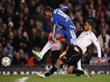 Didier Drogba of Chelsea shoots past Victor Ruiz of Valencia during the UEFA Champions League Group E match between Chelsea FC and Valencia CF at Stamford Bridge on December 6, 2011