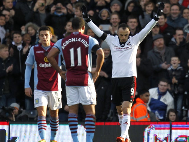 Fulham's Bulgarian striker Dimitar Berbatov celebrates scoring from the penalty spot during the English Premier League football match between Fulham and Aston Villa at Craven Cottage in London on December 8, 2013