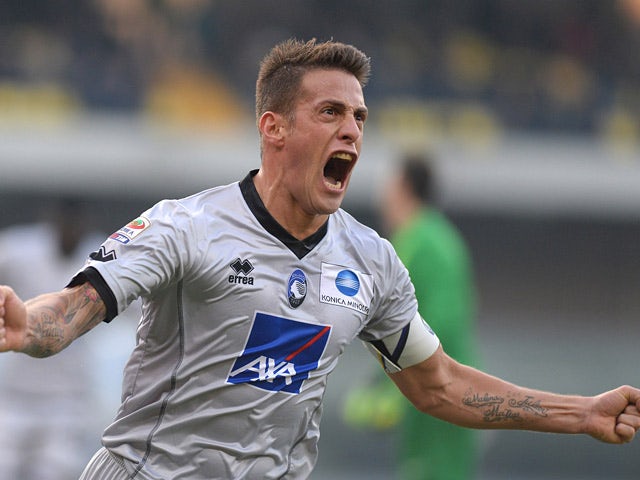 Atalanta's German Denis celebrates after scoring the opening goal against Hellas Verona during their Serie A match on December 8, 2013