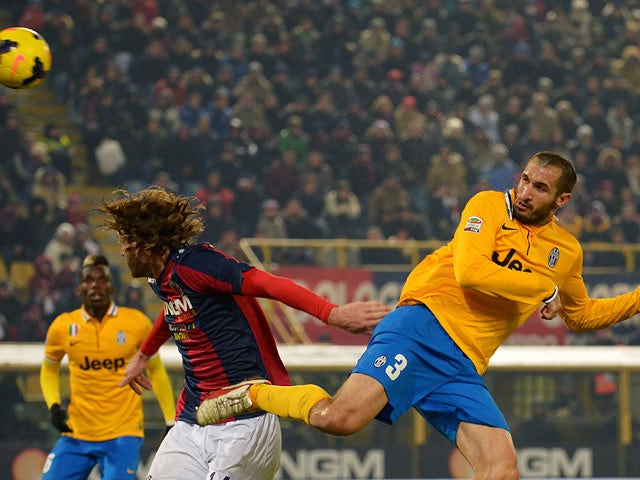 Juventus' Giorgio Chiellini scores his team's second goal against Bologna during their Serie A match on December 6, 2013
