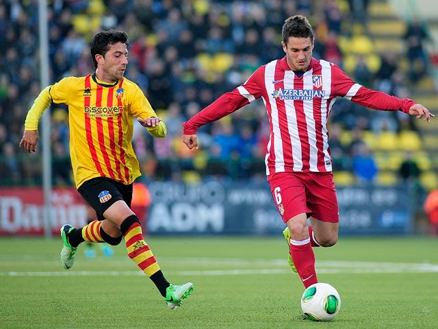 Sant Andreu's Ibon and Atletico Madrid's Koke in action during their Copa del Rey match on December 7, 2013