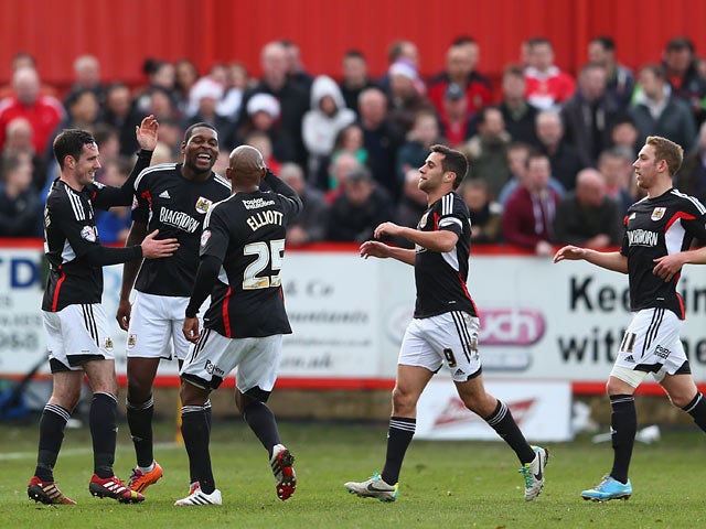 Bristol City's Jay Emmanuel-Thomas celebrates with teammates after scoring the opening goal against Tamworth during their FA Cup second round match on December 8, 2013