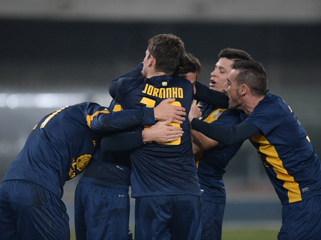Hellas Verona's Jorginho celebrates with teammates after scoring his team's second goal against Atalanta during their Serie A match on December 8, 2013