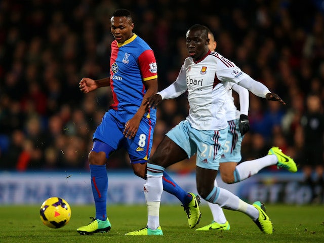 Kagisho Dikgacoi of Crystal Palace and Mohamed Diame of West Ham compete for the ball during the Barclays Premier League match on December 3, 2013
