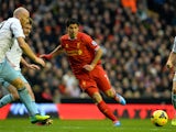 Liverpool's Uruguayan striker Luis Suarez runs with the ball during the English Premier League football match between Liverpool and West Ham United at Anfield in Liverpool on December 7, 2013