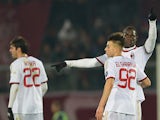 AC Milan Mario Balotelli (R) celebrates with teammate forwad Stephan el Shaarawy after scoring a free kick during the Serie A football match Livorno vs AC Milan at the Armando Picchi stadium in Livorno on December 7, 2013