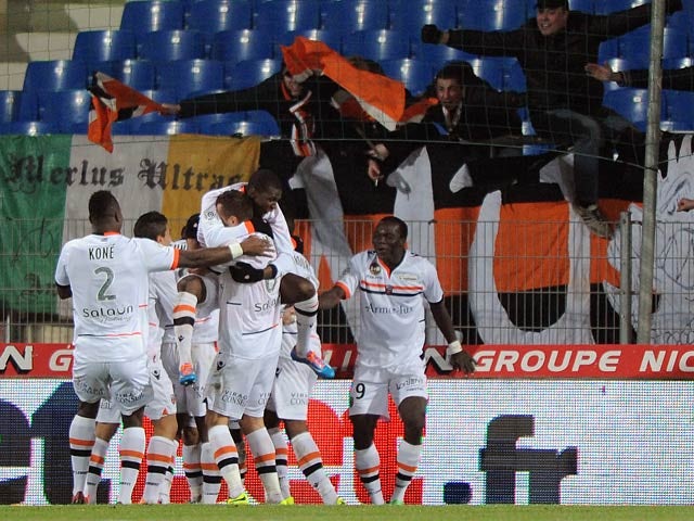 Lorient's players celebrate after scoring the opening goal against Montpellier during their Ligue 1 match on December 4, 2013