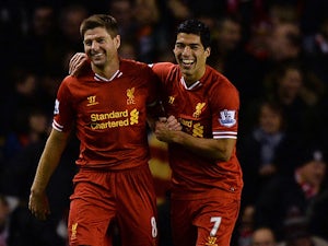 Liverpool's Luis Suarez celebrates with teammate Steven Gerrard after scoring his team's second goal against Norwich during their Premier League match on December 4, 2013