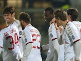 Milan's Mario Balotelli celebrates with teammates after scoring the opening goal against Livorno during their Serie A match on December 7, 2013