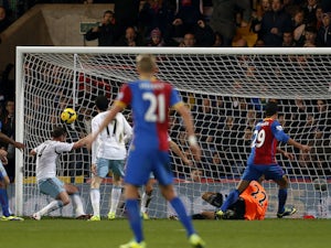 Crystal Palace striker Marouane Chamakh heads into the net for the opening goal during the English Premier League football match on December 3, 2013
