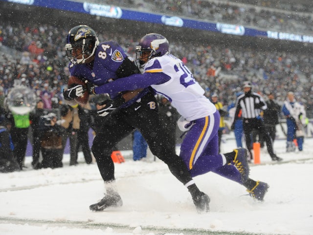 Tight end Ed Dickson #84 of the Baltimore Ravens beats cornerback Chris Cook #20 of the Minnesota Vikings for the game's first touchdown at M&T Bank Stadium on December 8, 2013