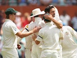 Australia's Mitchell Johnson is congratulated by teammates after taking the wicket of England's Stuart Broad during day three of the second Ashes test on December 7, 2013