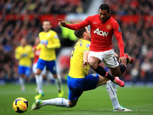 Man United's Nani and Newcastle's Mike Williamson in action during their Premier League match on December 7, 2013