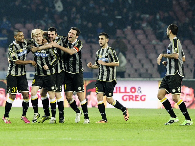 Udinese's players celebrate after scoring the Italian Serie A football match SSC Napoli vs Udinese at the San Paolo Stadium in Naples on December 7, 2013