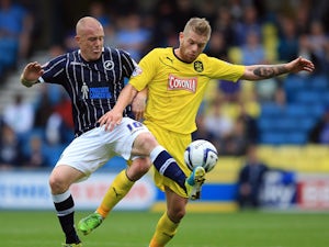 Nicky Bailey of Millwall battles with Adam Clayton of Huddersfield during the Sky Bet Championship match between Millwall and Huddersfield Town at The Den on August 17, 2013