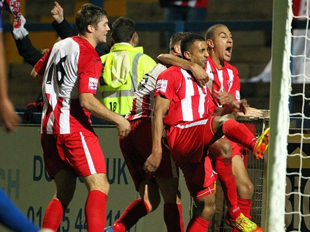 Brackley 's Owen Story celebrates with teammates after scoring his team's second goal against Macclesfield during their FA Cup match on December 7, 2013